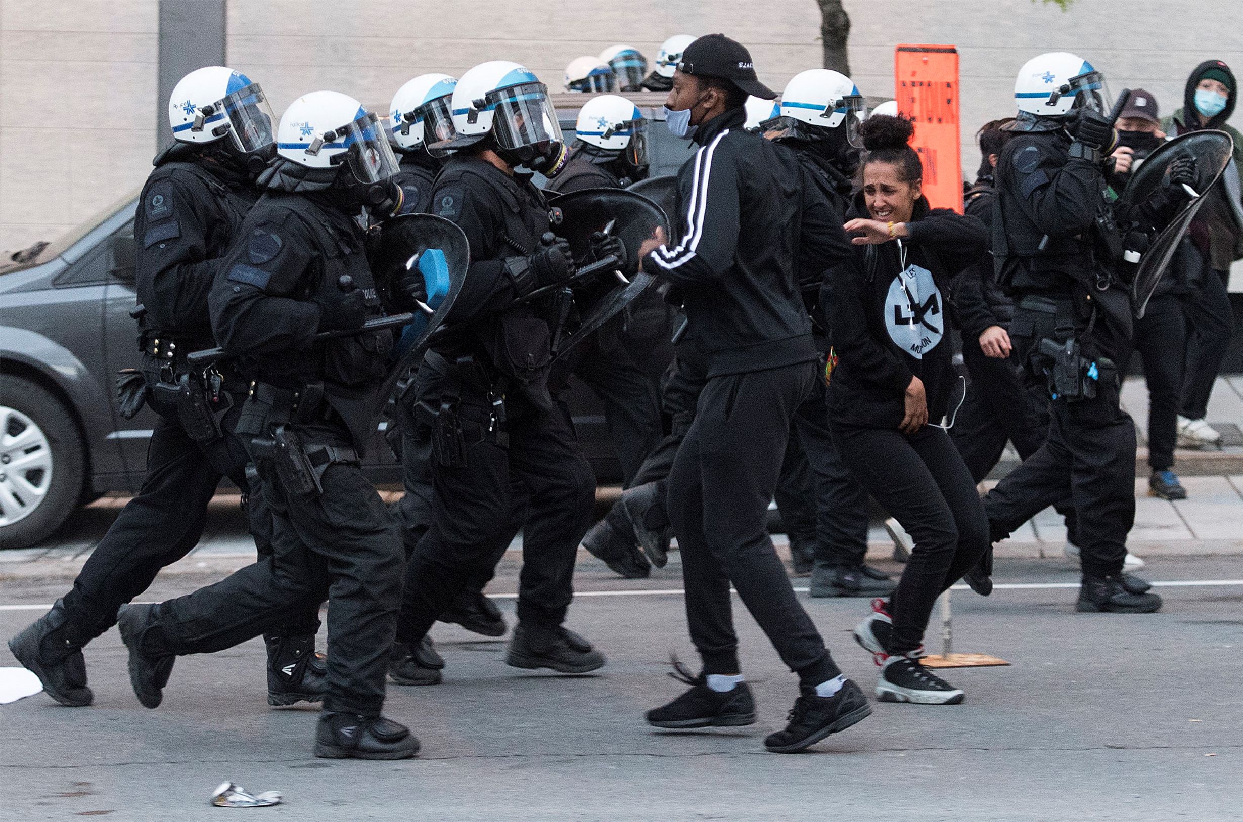 police_push_back_protesters_during_a_demonstration_calling_for_justice_in_the_death_of_george_floyd_and_victims_of_police_brutality._montreal_may_31_2020.the_canadian_press-_graham_hughes.jpg